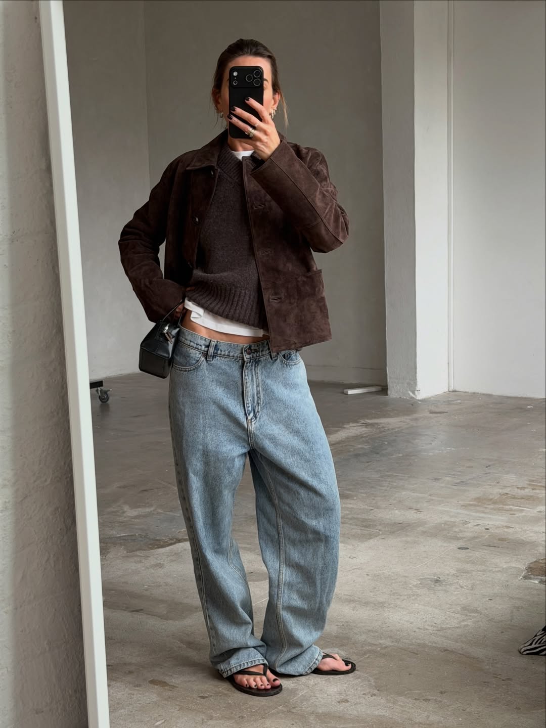 Hannah in a brown suede jacket and jeans