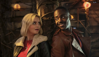 New Doctor Ncuti Gatwa and his new companion Ruby (Millie Gibson) pose back to back for the Doctor Who Holiday Special — The Church on Ruby Road