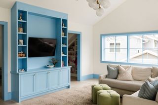 living room with blue cabinets and window frames