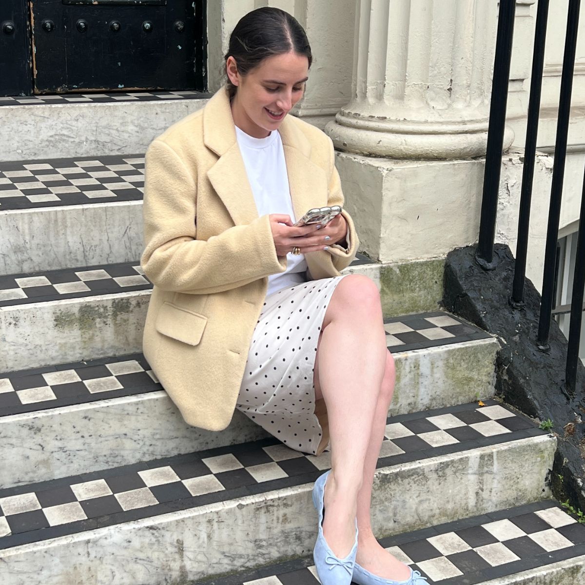 An image of Who What Wear SEO Writer Ava Gilchrist trying on the Reformation Suzanne Ballet Flats.