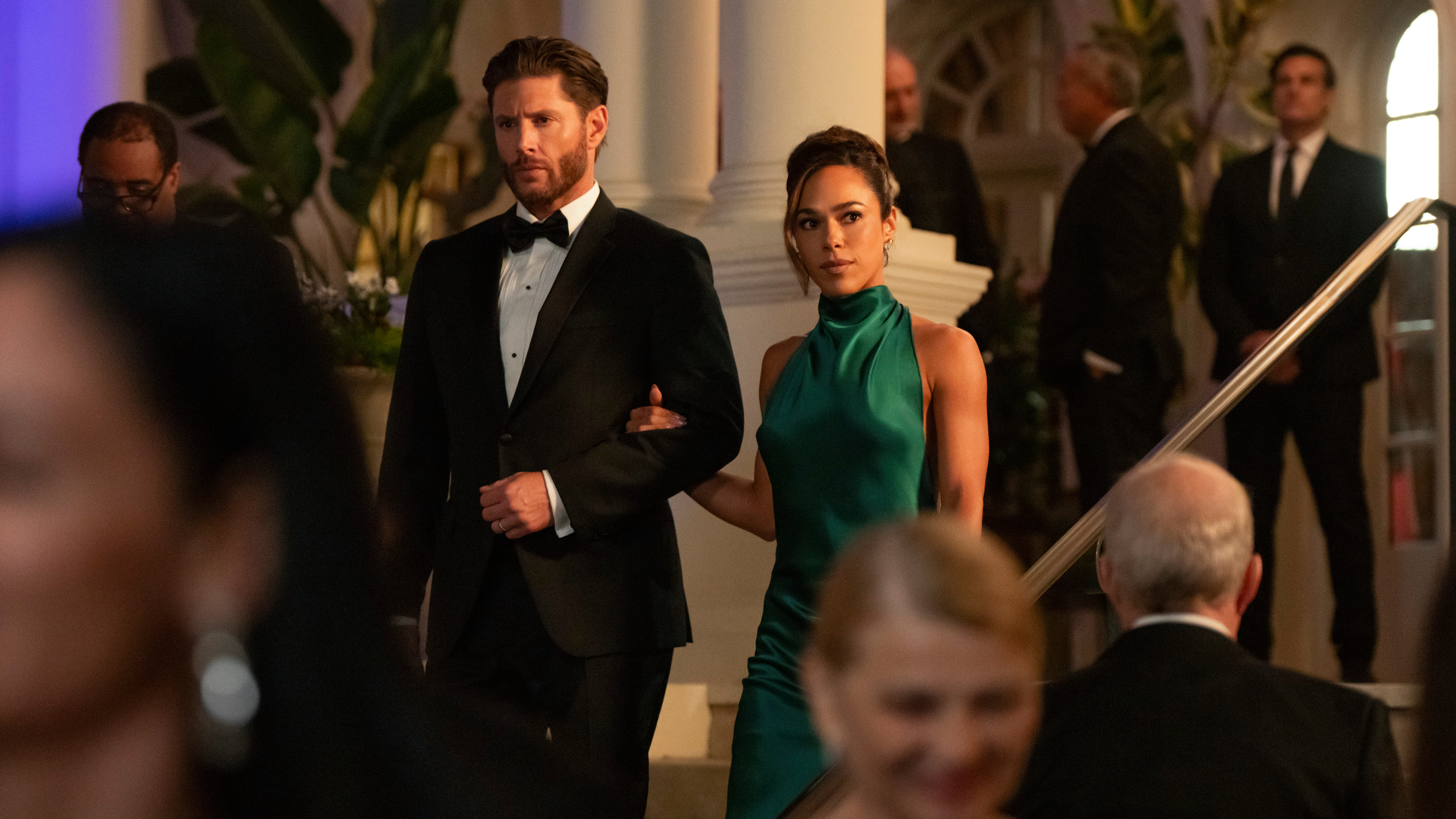 Mark (Jensen Ackles, left) and Amber (Jessica Camacho) in formalwear attending a soiree in a scene from Prime Video's "Countdown"