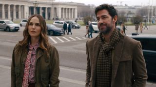 Natalie Portman and John Krasinski standing next to each other and looking forward in The Fountain of Youth. 