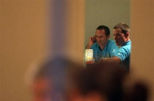 Astana team coach Mario Kummer (L) talks on the phone