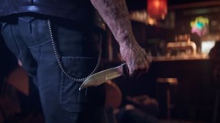 A screenshot of a man holding a knife during the Marvel Wolverine game trailer.