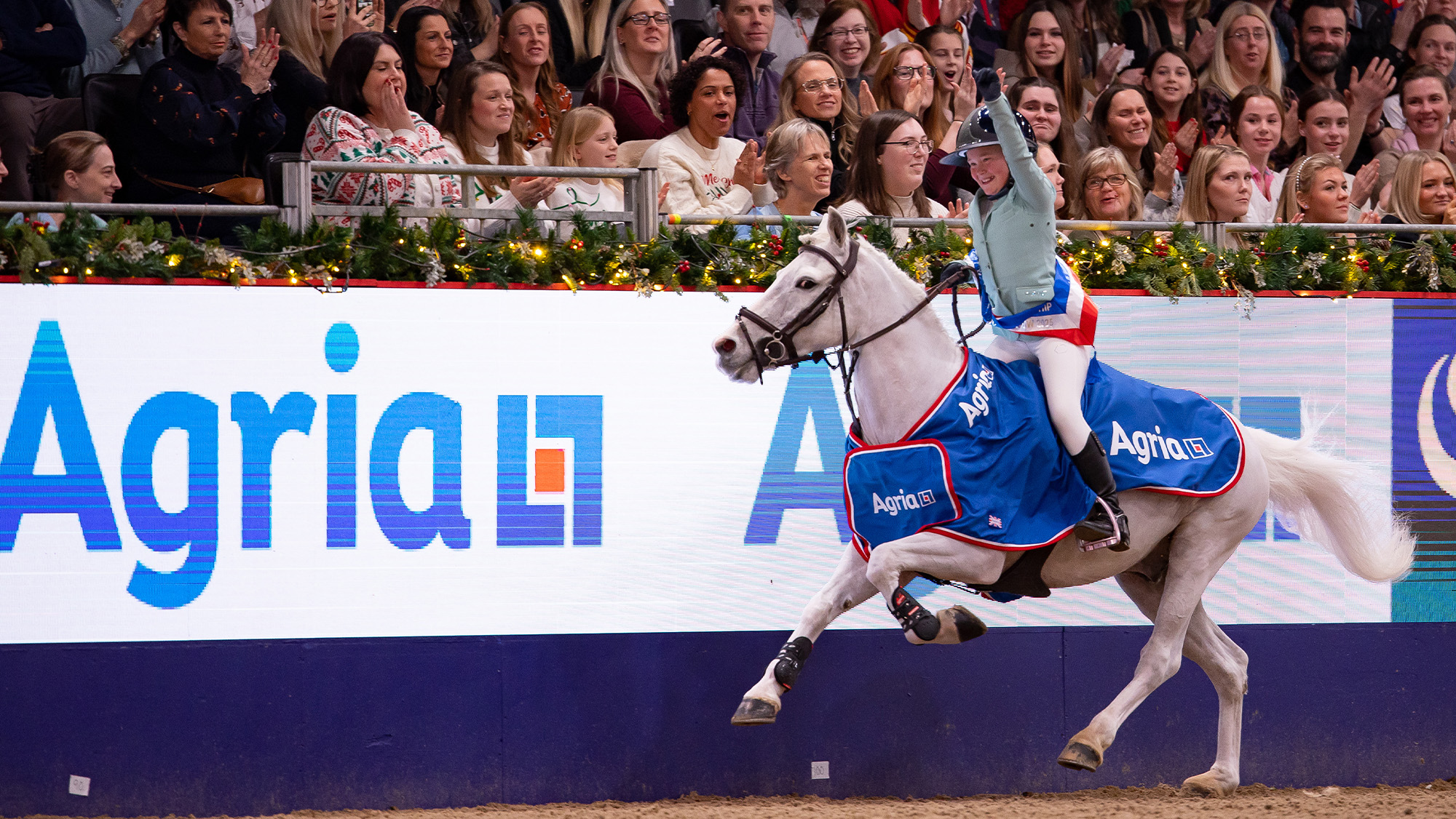 Anya Dewey Clarke rides lap of honour at London International Horse Show