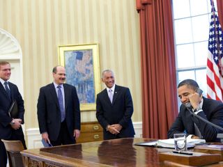 President Barack Obama makes a phone call with the crew of the Space Shuttle Discovery and the International Space Station from the Oval Office, March 3, 2011.