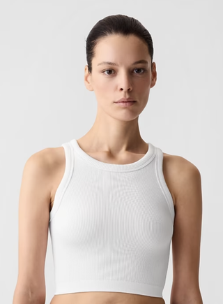 a model wears a white tank top by Gap
