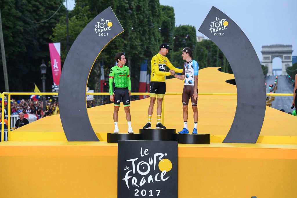Chris Froome shakes hands with Tour de France third-place finisher Romain Bardet.