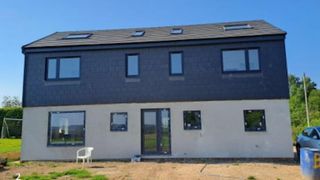 A white and grey two-storey extension