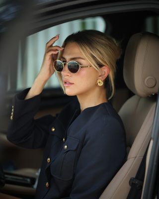 Cass Dimicco wearing Aureum earrings and sunglasses.