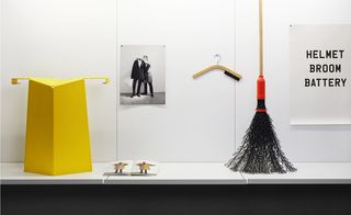 Objects on white shelf and broom