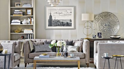 Living room with cream sofa, patterned rug and rust armchair.