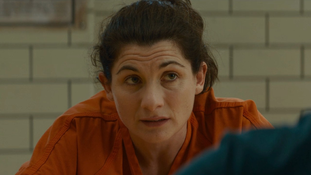 Jodie Whittaker as Lizzy in an orange prison jumpsuit in Office Romance.