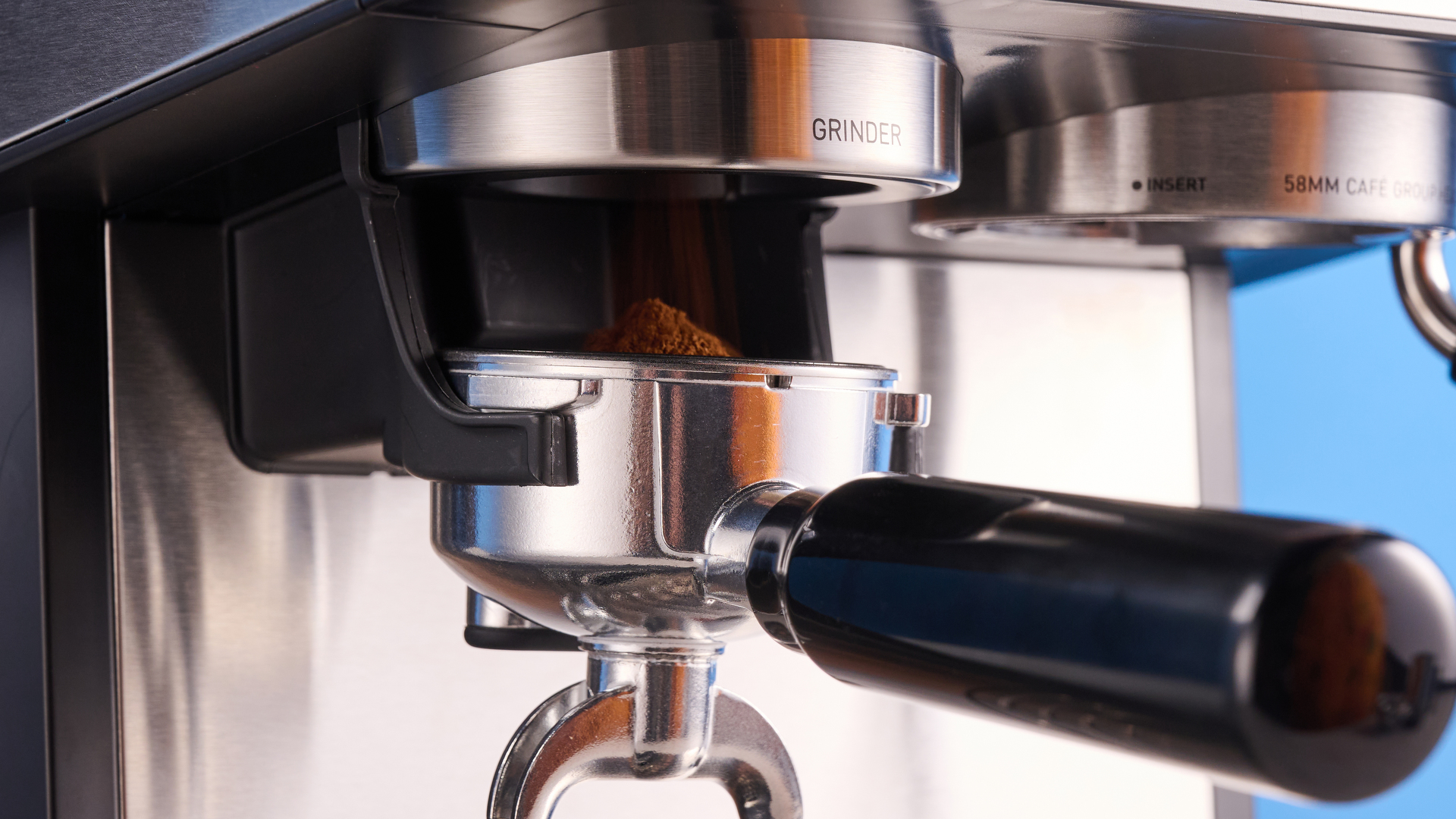 the gevi espresso machine with grinder showing its bean hopper, steam wand, and control screen with a silver dial and drip tray