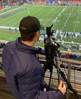 A camera operator films an XFL game with JVC camera.