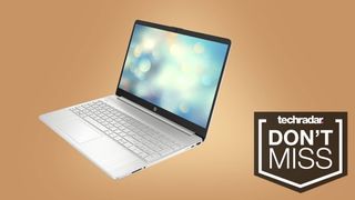 An HP 15 laptop against a butterscotch background