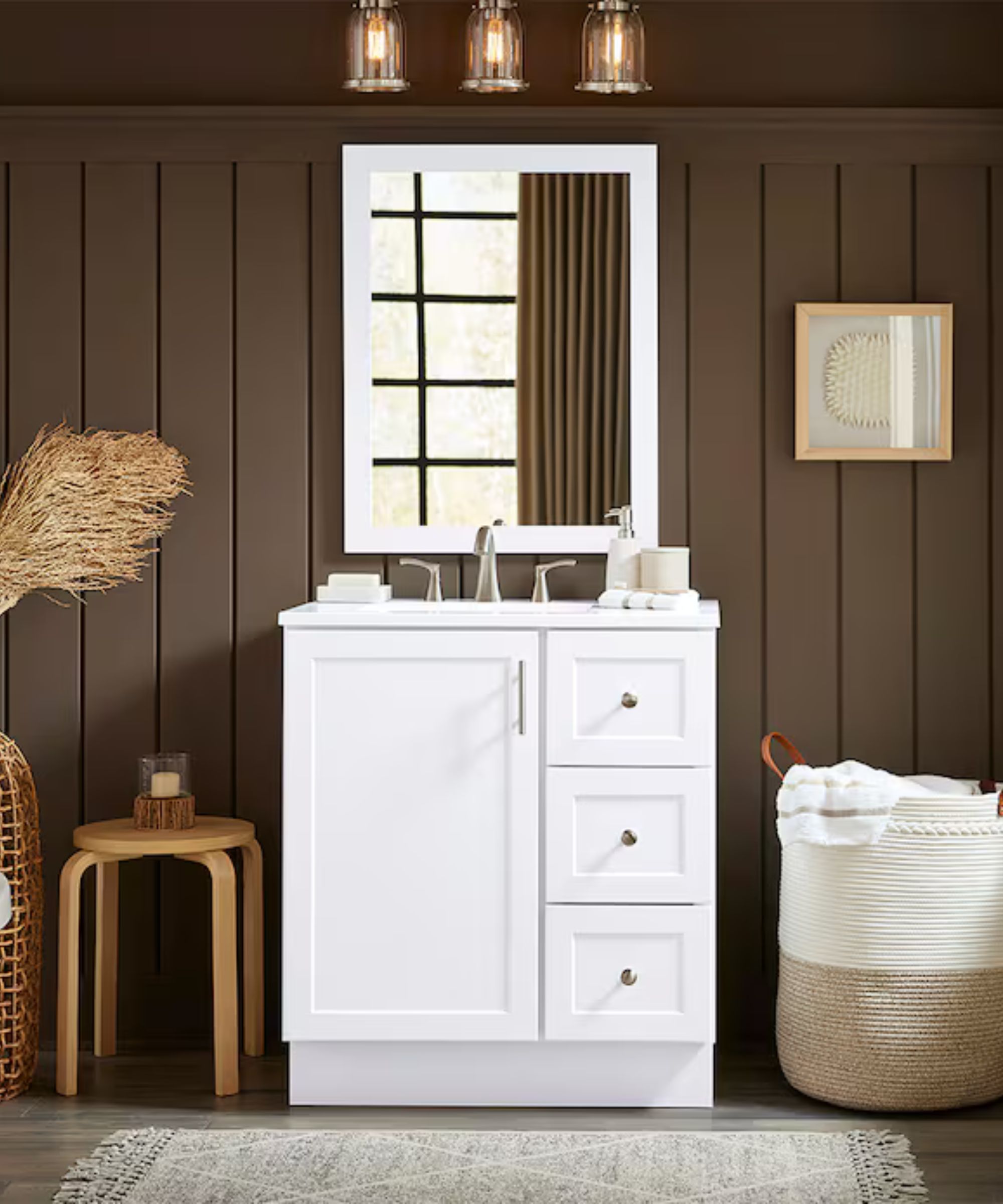 A bathroom with brown paneled walls, a white single vanity, and a white framed mirror