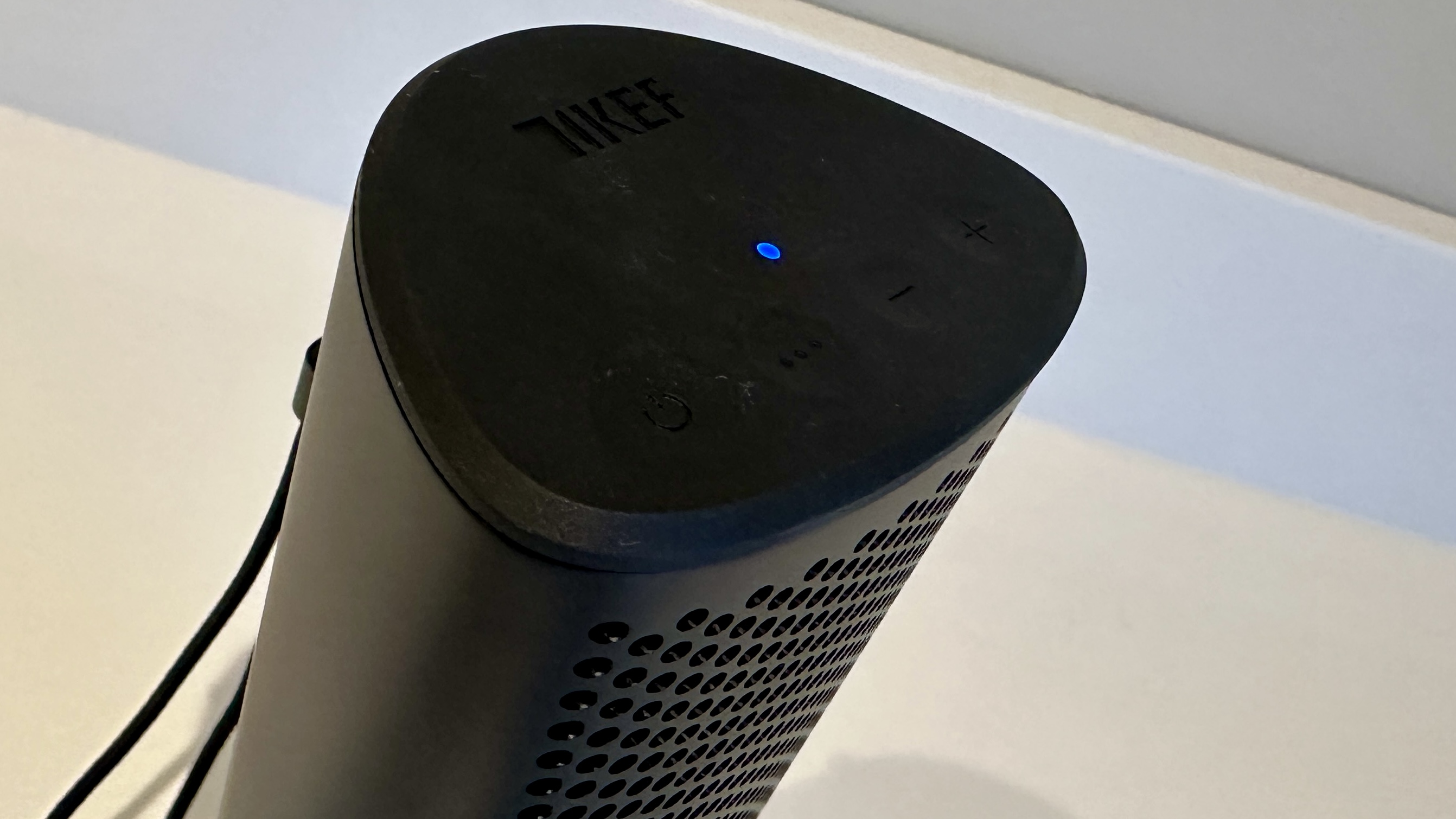 KEF Muo 2025 in black, on a white table