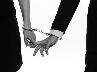 A couple in handcuffs.