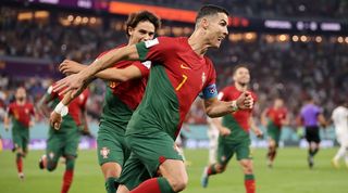 Cristiano Ronaldo celebrates after scoring a penalty for Portugal against Ghana to become the first player ever to net in five different World Cups.