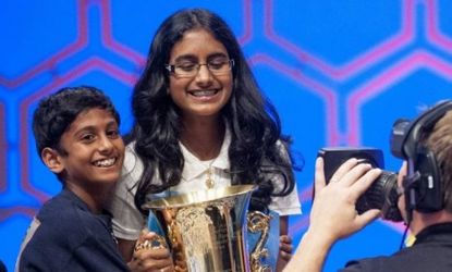 Snigdha Nandipati, 14, of San Diego, Calif., is hugged by her brother, Sujan, 10, after she won the 85th Annual Scripps National Spelling Bee.