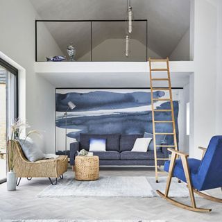 Blue living room with a rocking chair and a mezzanine with ladder