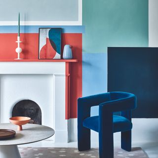 Living room with blue statement armchair and abstract wall