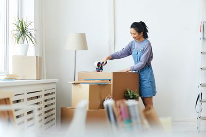 Decluttering tips: A woman organising her belongings at home
