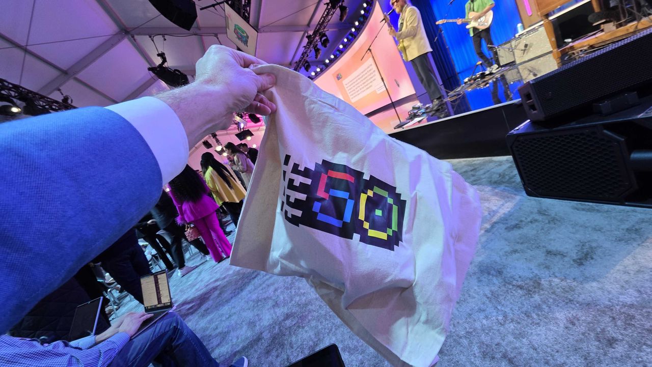 Swag celebrating Microsoft milestones and a presentation at the Microsoft 50th anniversary event