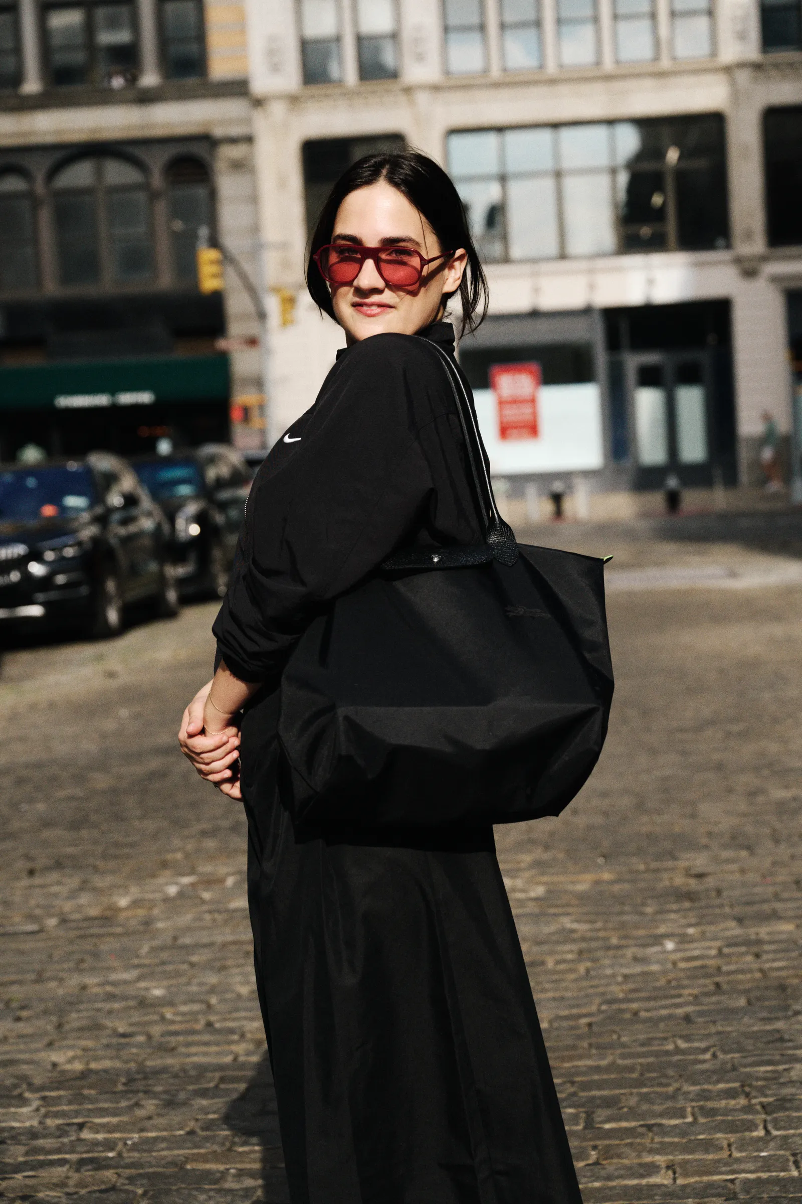 Julia Marzovilla carrying the Longchamp Le Pliage tote bag at new york fashion week
