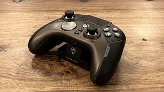 The Turtle Beach Stealth Ultra controller place on its stand on a wooden surface.