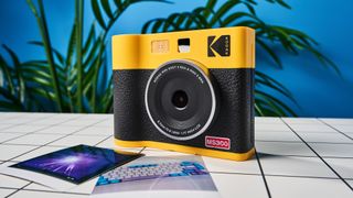 A black and yellow Kodak Mini Shot 3 Era 2-in-1 instant camera and printer