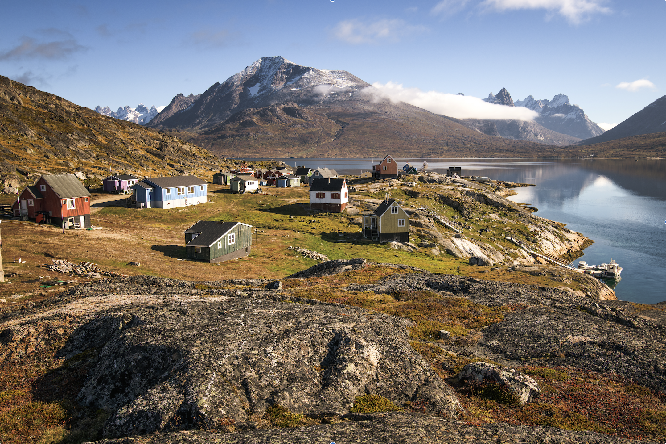 Greenland landscape in spring/summer with fjord and several houses, among the mountains and the hills
