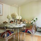 dining room with white flower vase and glass top dining table