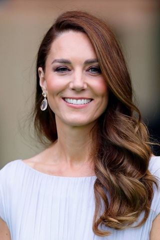 Kate Middleton headshot with a side parted curly hairstyle
