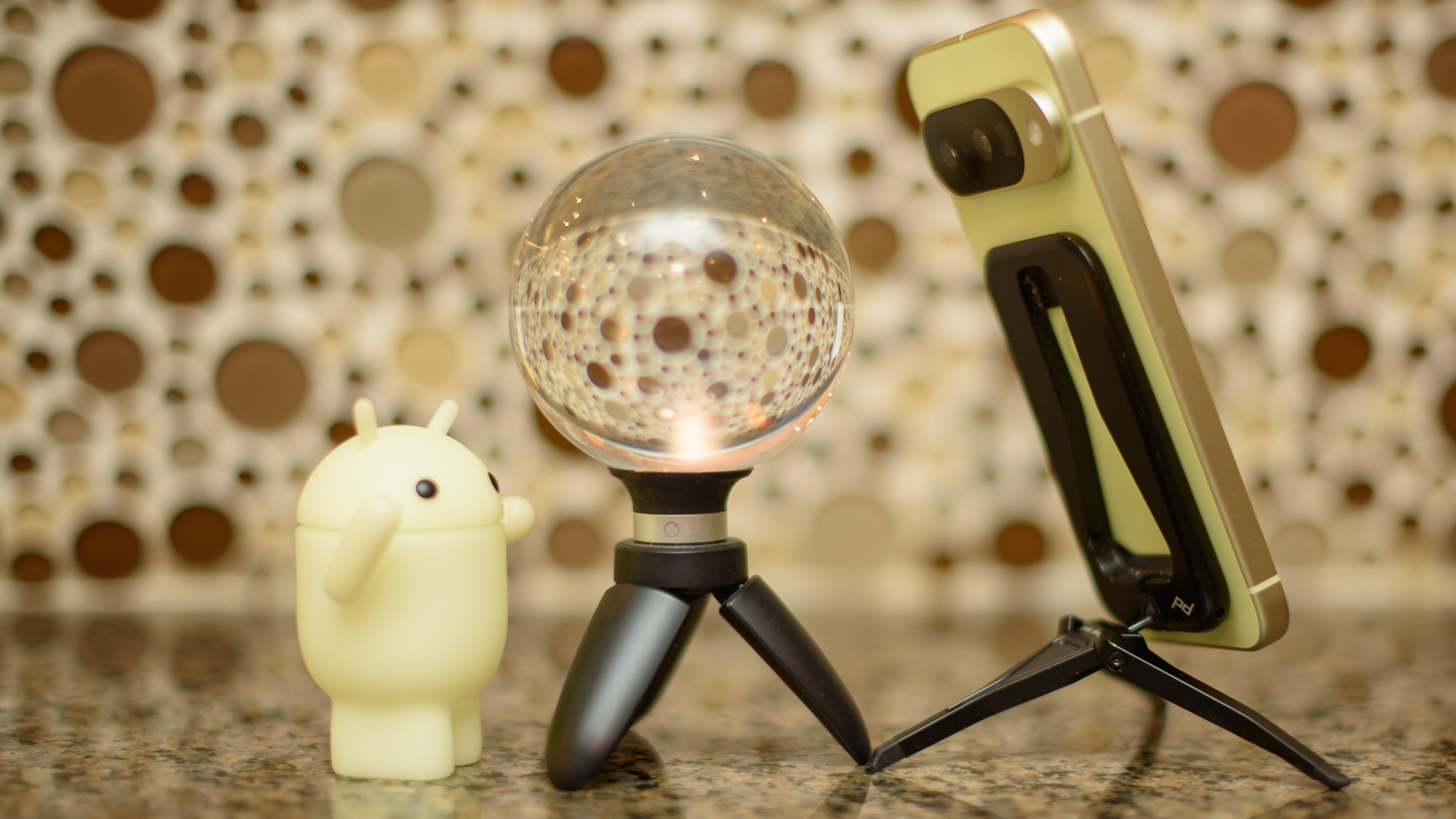 Google Pixel 10 in Lemongrass against a bubbly backsplash