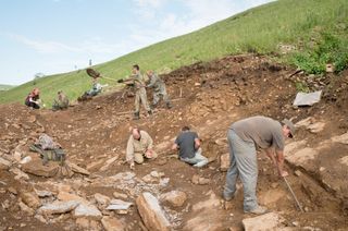 researhers excavate at a dinosaur bonebed in southeastern Siberia.