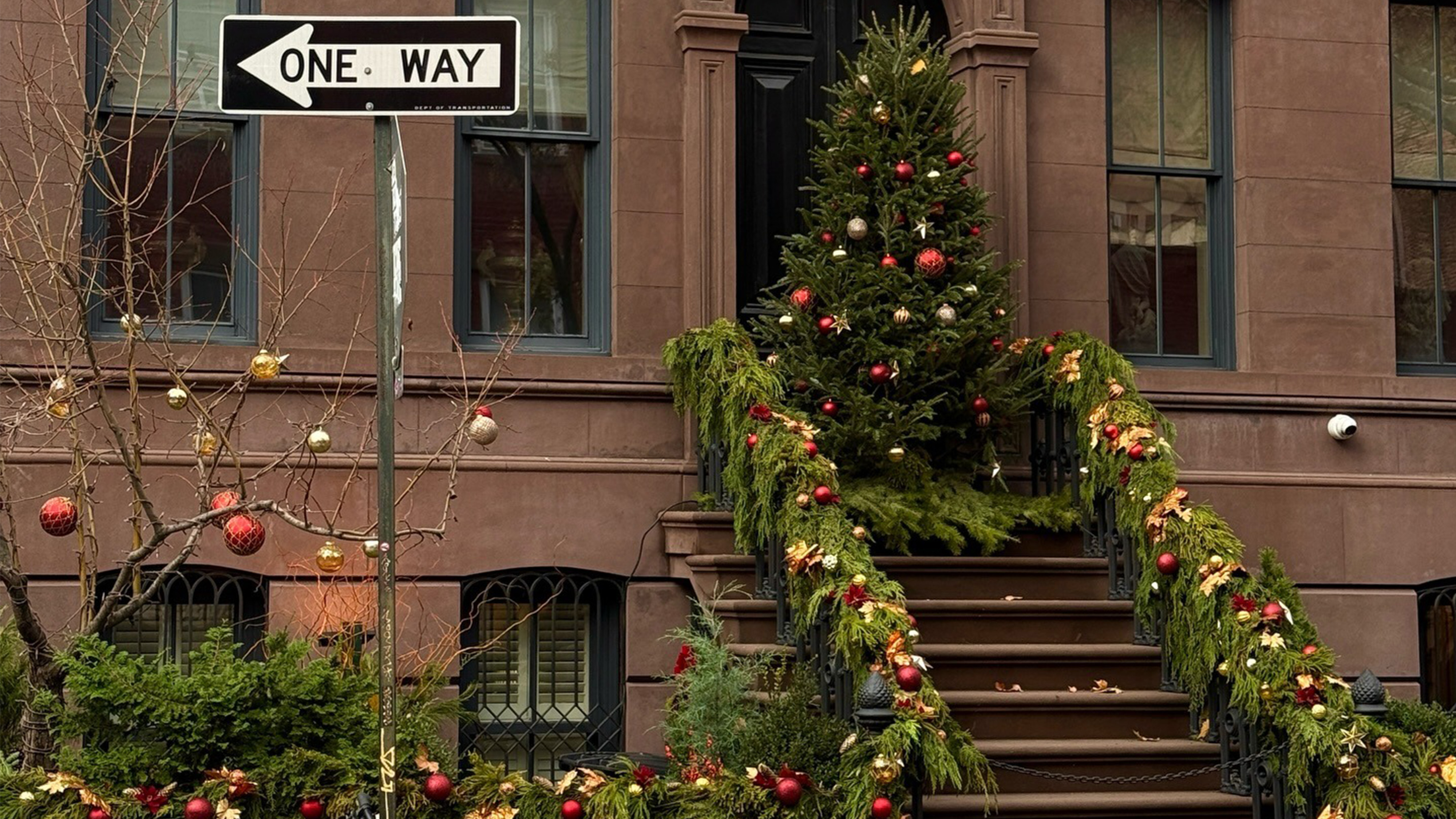 Brownstone with Christmas tree and holiday decorations.