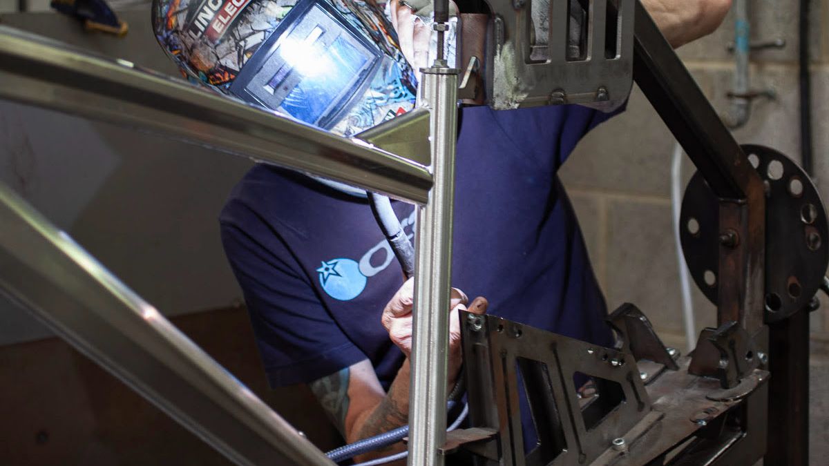 A welder constructing a bike frame