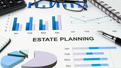 Estate planning documents with a pen, calculator and eyeglasses.