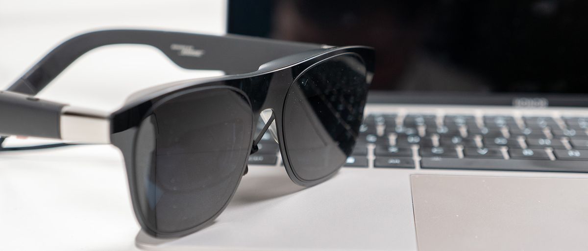 A pair of Xreal One glasses on a laptop, cropped to a 21:9 aspect ratio