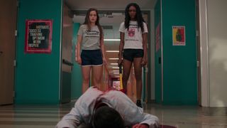 Juliette and Calliope stand over a dead body in their high school in Netflix's First Kill TV series