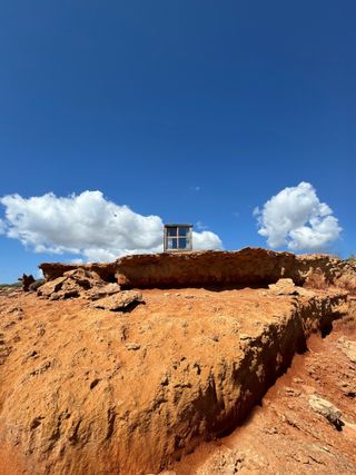 tiny cabin in desert landscape