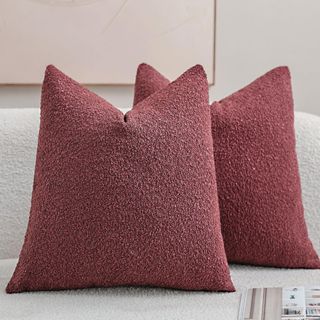 Two DEZENE Textured Boucle Throw Pillow Covers in burgundy on a sofa