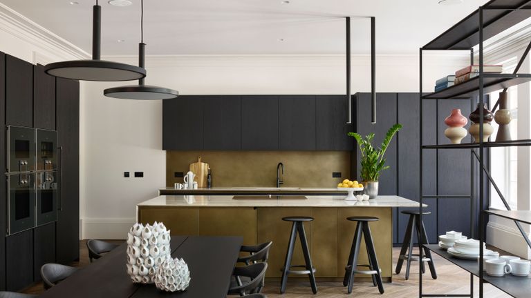 a modern black and brass kitchen