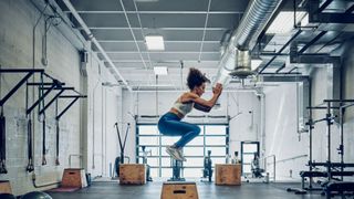Woman doing box jumps at gym