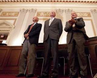 Apollo 11 astronauts, from left, Michael Collins, Neil Armstrong and Buzz Aldrin stand in recognition of astronaut John Glenn during the U.S House of Representatives Committee on Science, Space and Technology tribute to the Apollo 11 astronauts at the Cannon House Office Building on Capitol Hill on July 21, 2009, in Washington.