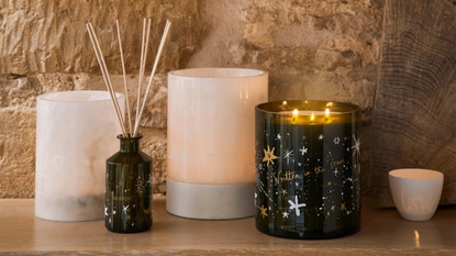 Bamford's christmas candle collection on a stone shelf with diffusers too