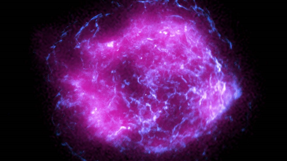 This image of the supernova remnant Cassiopeia A combines some of the first X-ray data collected by NASA’s Imaging X-ray Polarimetry Explorer, shown in magenta, with high-energy X-ray data from NASA’s Chandra X-Ray Observatory, in blue.