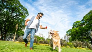 Man playing fetch with dog